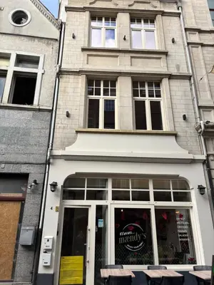 a building with a store front with a window at Apartment central Lier in Lier