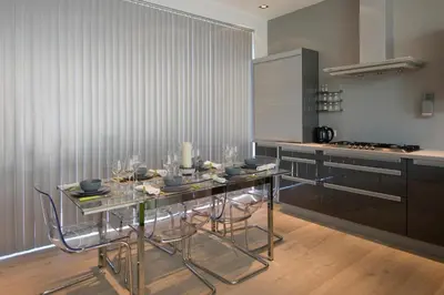 a kitchen with a table and chairs in a kitchen at Aan Den Oever Logies in Korbeek-Dijle