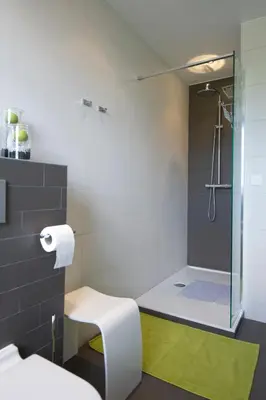a bathroom with a shower with a glass door at Aan Den Oever Logies in Korbeek-Dijle