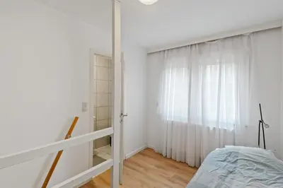 a bedroom with a bed and a window at Antwerp Parkside apartments in Antwerp