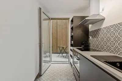 a kitchen with a door leading to a dining room at Antwerp Parkside apartments in Antwerp