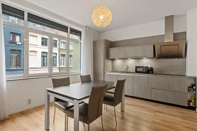 a kitchen and dining room with a table and chairs at Antwerp Parkside apartments in Antwerp