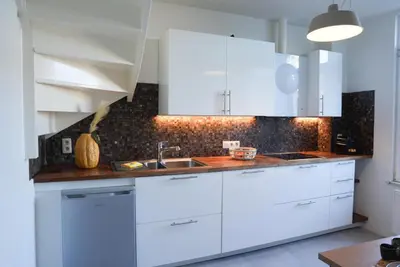 a kitchen with white cabinets and a sink at Antwerp Parkside apartments in Antwerp