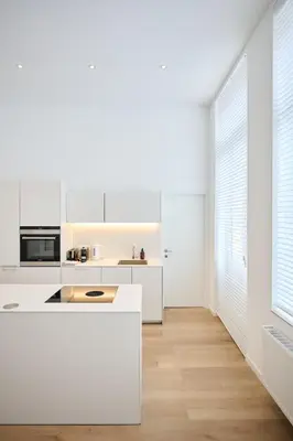 a kitchen with white countertops and white cabinets at Louise City 2 in Brussels
