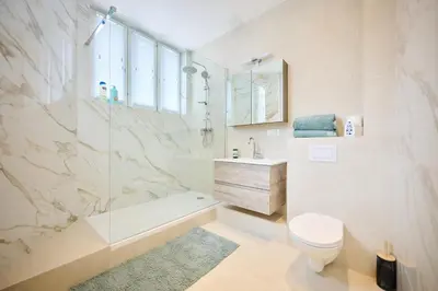 a bathroom with a shower and a toilet and a sink at Louise City 2 in Brussels