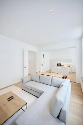 a living room with a couch and a table at Louise City 2 in Brussels