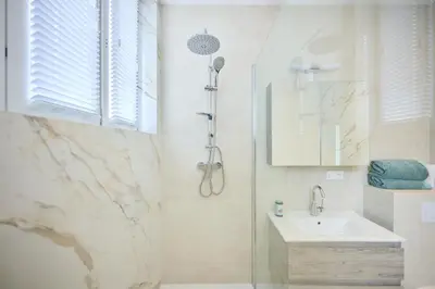 a bathroom with a sink and a shower at Louise City 2 in Brussels