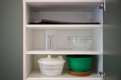 a cupboard with bowls and other kitchen items in it at Apartement Berthelot 5 in Brussels