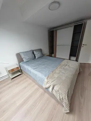 a bedroom with a large bed in a white room at The Nest in Antwerp