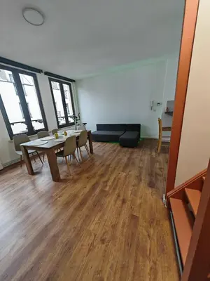 an empty room with a table and chairs in it at The Nest in Antwerp