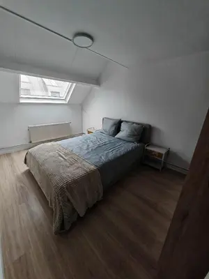 a bedroom with a bed in a room with a window at The Nest in Antwerp