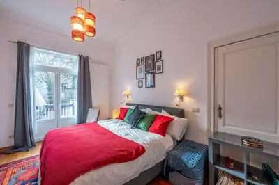 a bedroom with a large bed and a window at Euro Edens Brussels - Cozy Family Suite in Brussels