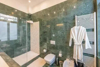 a bathroom with a shower and a toilet and a sink at Euro Edens Brussels - Cozy Family Suite in Brussels