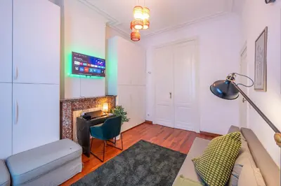 a living room with a couch and a fireplace at Euro Edens Brussels - Cozy Family Suite in Brussels