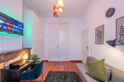 a living room with a couch and a tv at Euro Edens Brussels - Cozy Family Suite in Brussels