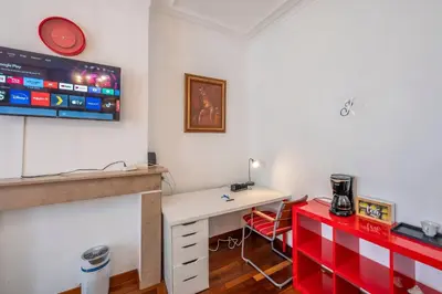 a room with a desk and a tv on the wall at Euro Edens Cosy Historic Home in Brussels Jacuzzi, Garden, Central Location in Brussels