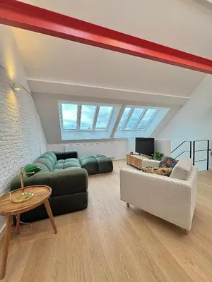 a living room with two couches and a tv at Duplex Design & Élégant au Coeur de Bruxelles in Brussels