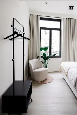 a bedroom with a bed and a table and a chair at ROMY ANTWERP Sint-Jansvliet in Antwerp
