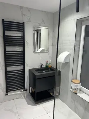 a bathroom with a black sink and a mirror at Sisel Apart House in Temse