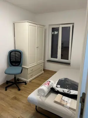 a bedroom with a bed and a chair and a dresser at Sisel Apart House in Temse