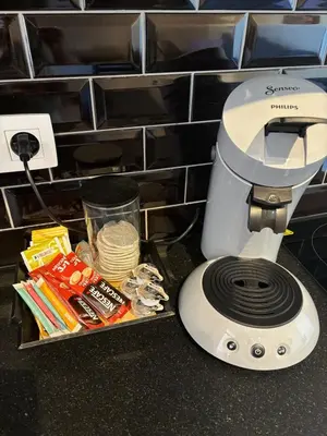 a hair dryer sitting on a counter next to some food at Modern apartment - Lier in Lier