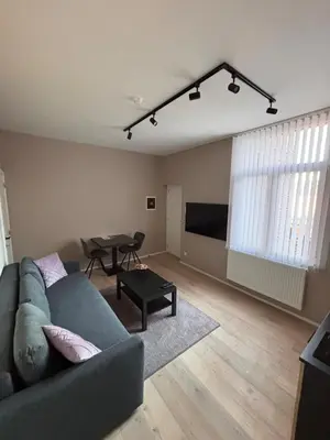 a living room with a couch and a table at Modern apartment - Lier in Lier