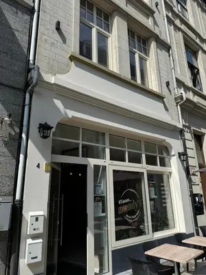 a white building with a table in front of it at Modern apartment - Lier in Lier