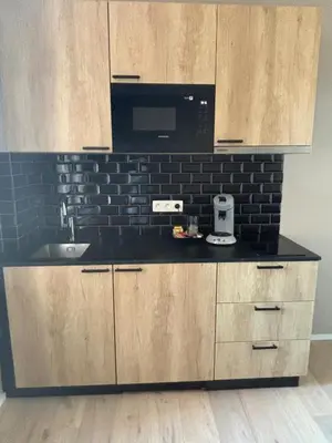 a kitchen with a sink and a microwave at Modern apartment - Lier in Lier