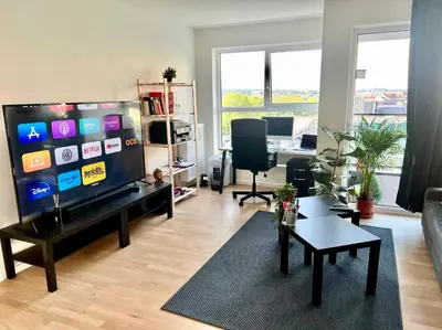 a living room with a large flat screen tv at Elegant Apartment Near Atomium Ideal for Families in Brussels