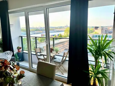 a room with a large window with a table and chairs at Elegant Apartment Near Atomium Ideal for Families in Brussels