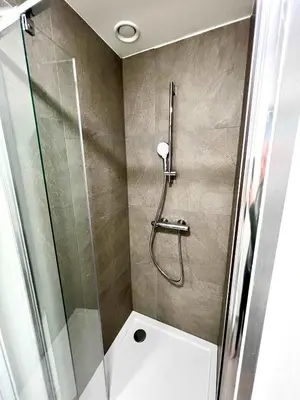 a bathroom with a shower and a toilet in it at Elegant Apartment Near Atomium Ideal for Families in Brussels