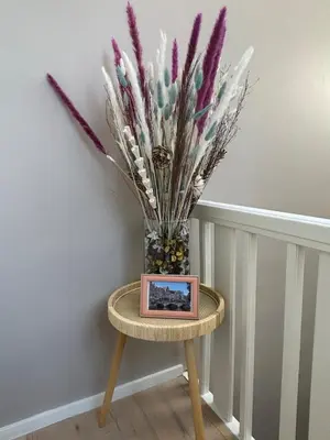a small table with a vase of flowers on it at Minimalist apartment - Lier center in Lier