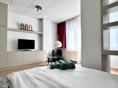 a bedroom with a bed with four pillows on it at Stunning Central Studio 2 Min from Grand Place in Brussels