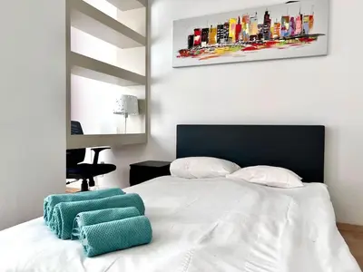 a bedroom with a white bed with two pillows on it at Stunning Central Studio 2 Min from Grand Place in Brussels
