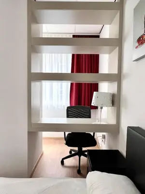a bedroom with a desk and a bed and a window at Stunning Central Studio 2 Min from Grand Place in Brussels