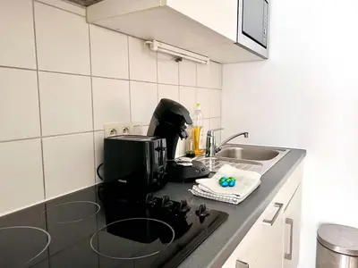 a kitchen with a sink and a stove top oven at Stunning Central Studio 2 Min from Grand Place in Brussels