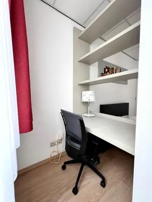 a office with a desk and a chair in a room at Stunning Central Studio 2 Min from Grand Place in Brussels