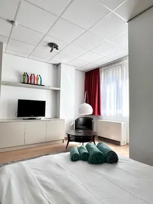 a bedroom with a bed with four pillows on it at Stunning Central Studio 2 Min from Grand Place in Brussels