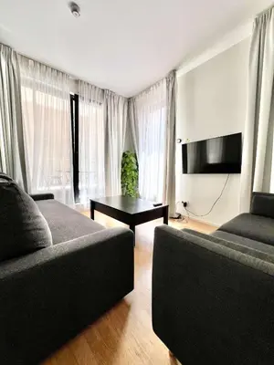 a living room with a couch and a table at Lovely Studio with Balcony by Grand Place for 4 in Brussels