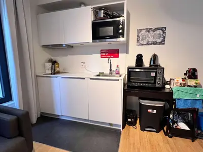 a small kitchen with a sink and a microwave at Lovely Studio with Balcony by Grand Place for 4 in Brussels