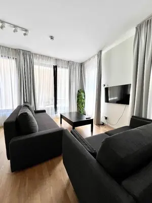 a living room with two black couches and a table at Lovely Studio with Balcony by Grand Place for 4 in Brussels
