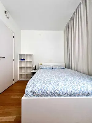 a white bedroom with a bed and a window at Lovely Studio with Balcony by Grand Place for 4 in Brussels
