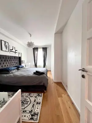 a bedroom with a bed and a window at Cosy Family Apartment for up to 9 guests near Brussels Midi Station in Brussels
