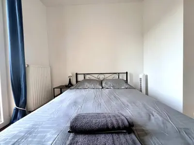 a bed with two pillows on it in a bedroom at Cosy Family Apartment for up to 9 guests near Brussels Midi Station in Brussels