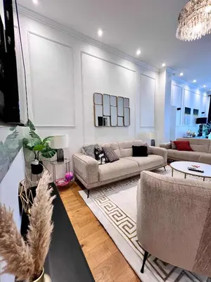 a living room with two couches and a chandelier at Cosy Family Apartment for up to 9 guests near Brussels Midi Station in Brussels