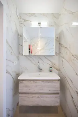 a bathroom with a sink and a mirror at Gallery Louise 2 in Brussels