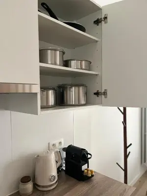 a kitchen with a counter with pots and pans on shelves at FDS Luxe House in Ghent