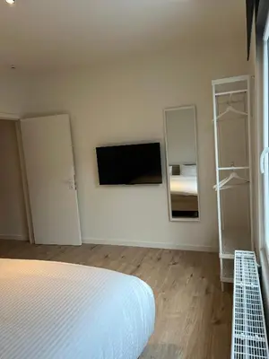 a white room with a bed and two mirrors at FDS Luxe House in Ghent