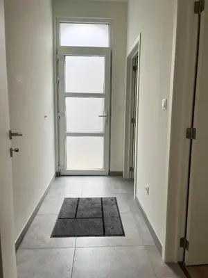 an empty hallway with a door and a rug at FDS Luxe House in Ghent