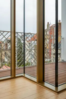an empty room with views of a city from windows at New Apartment center of Trendy St Gille in Brussels